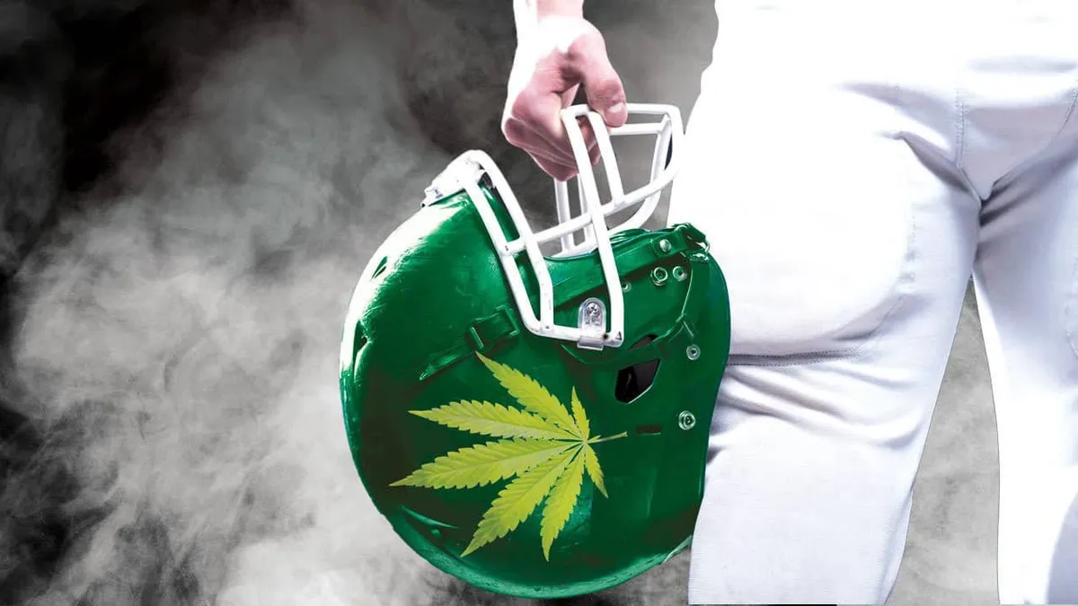 American football helmet decorated with a cannabis leaf