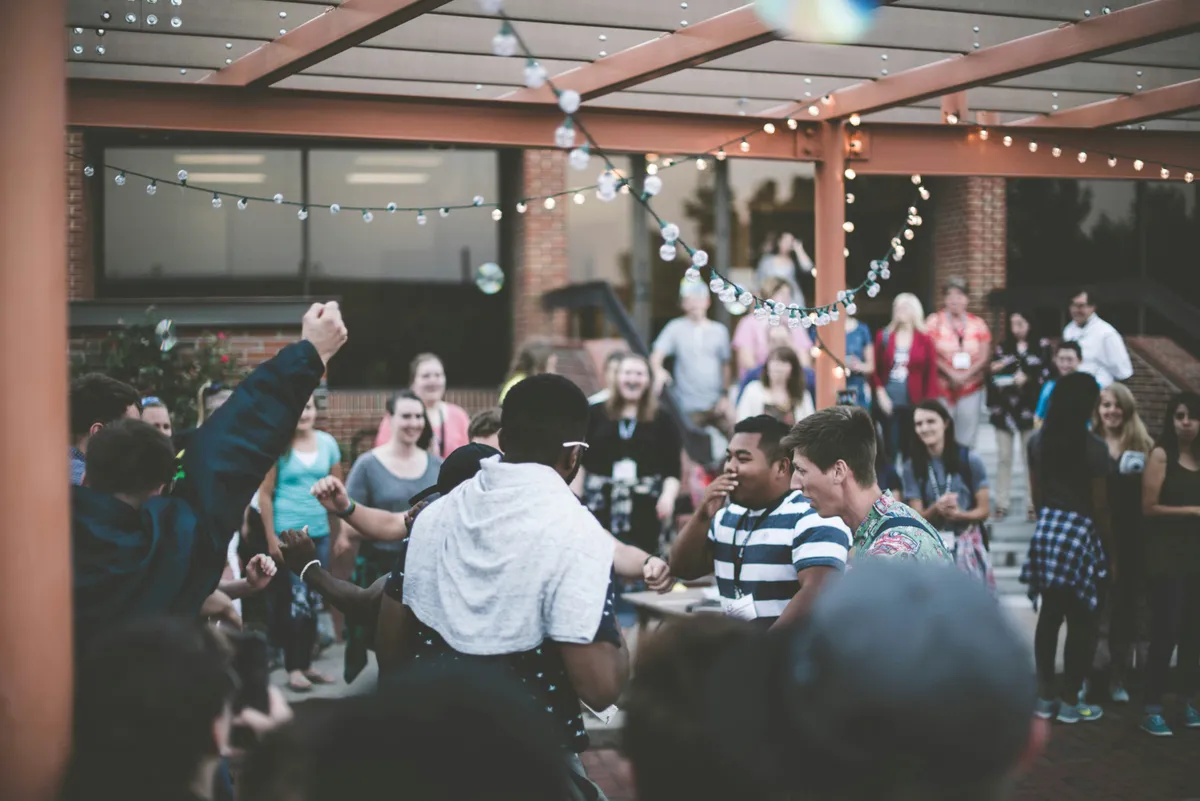 People gathered around tables at an outdoor event