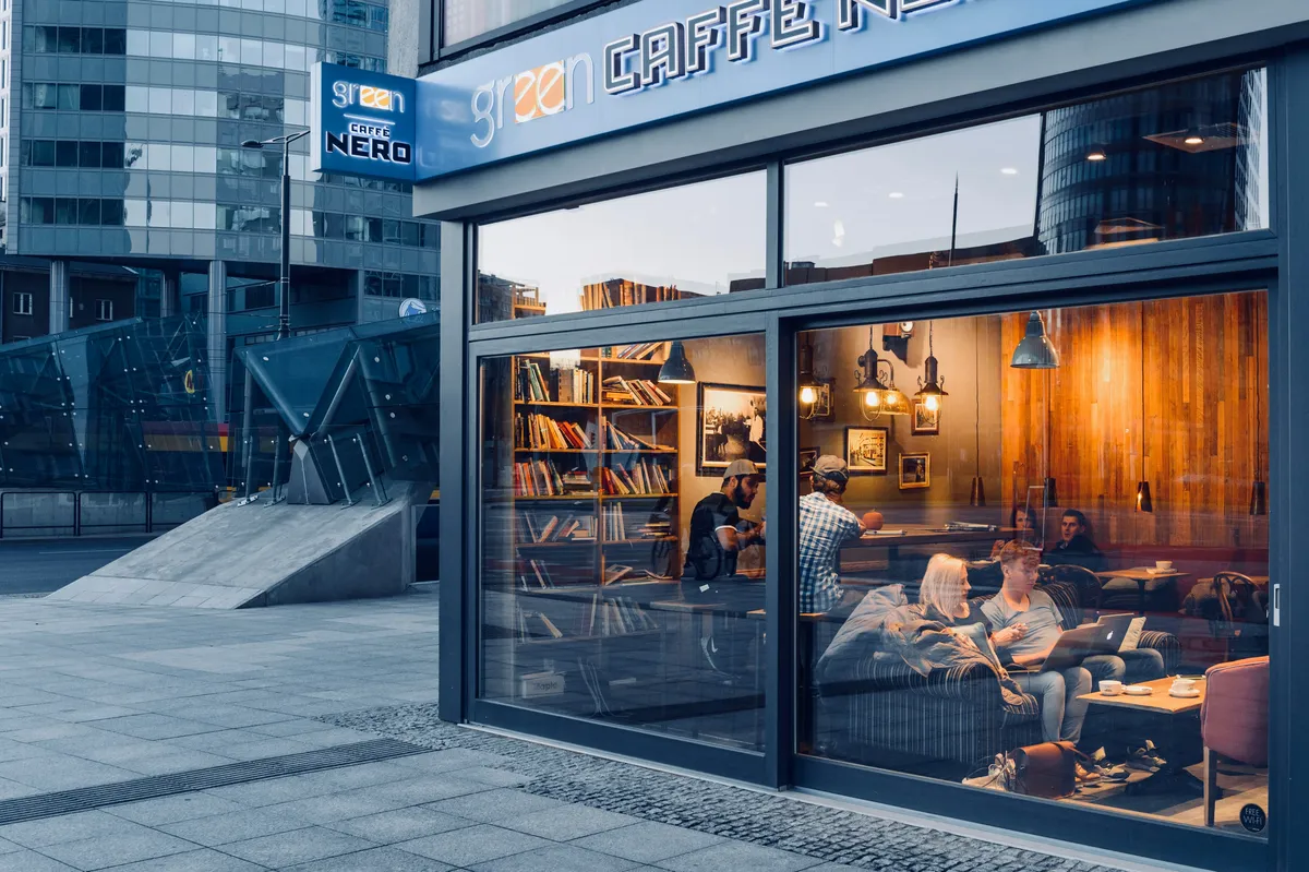 Glass-fronted café with people seated inside
